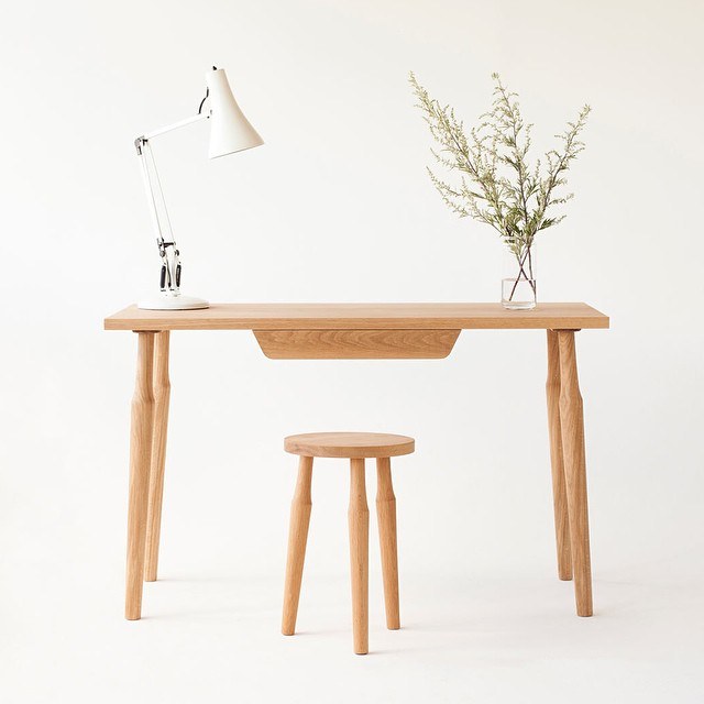 A wooden desk and stool